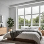 A small but airy bedroom with white walls and a large windowfeat